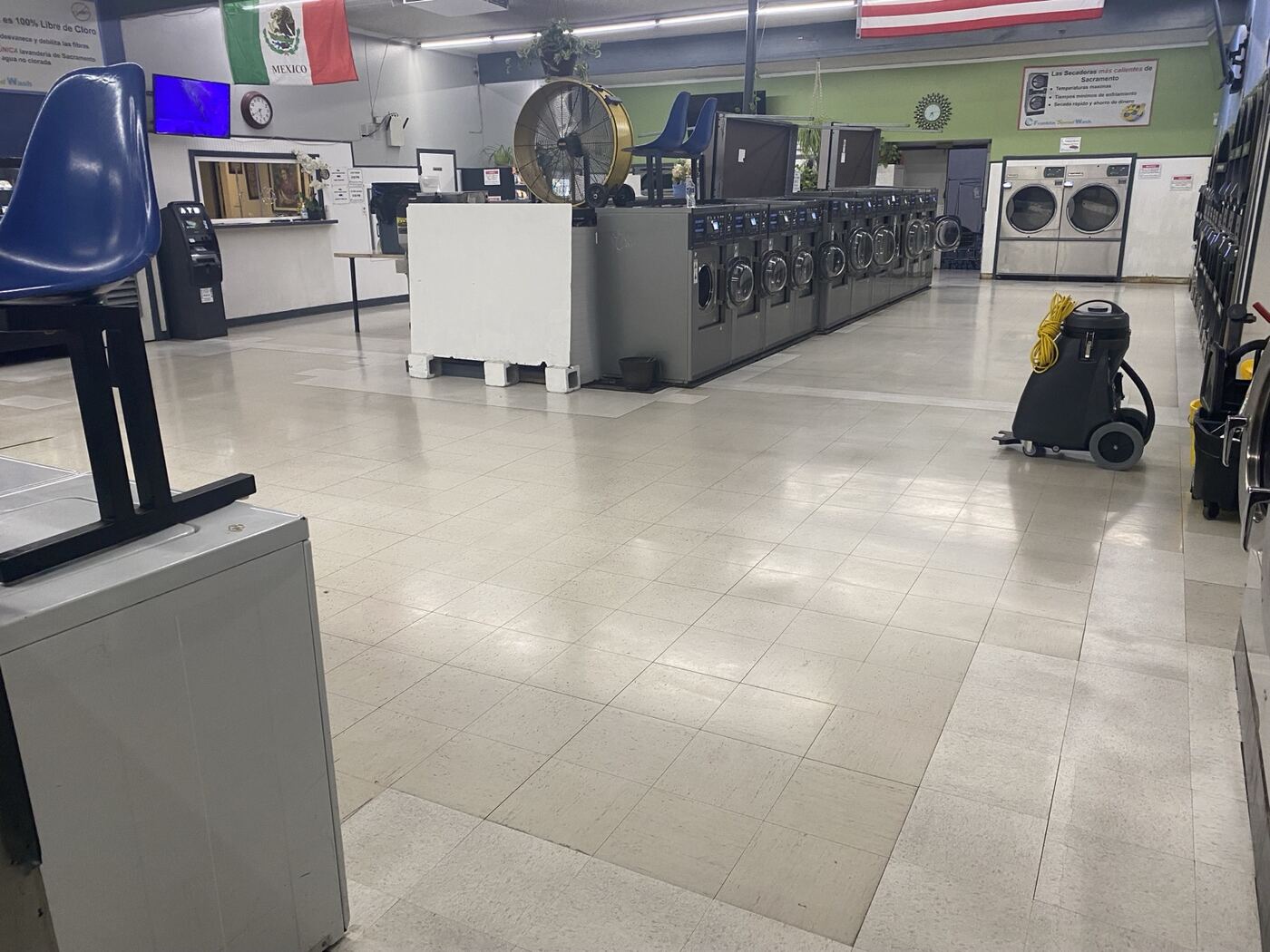 High-gloss VCT aisle in a commercial laundromat after Timla work