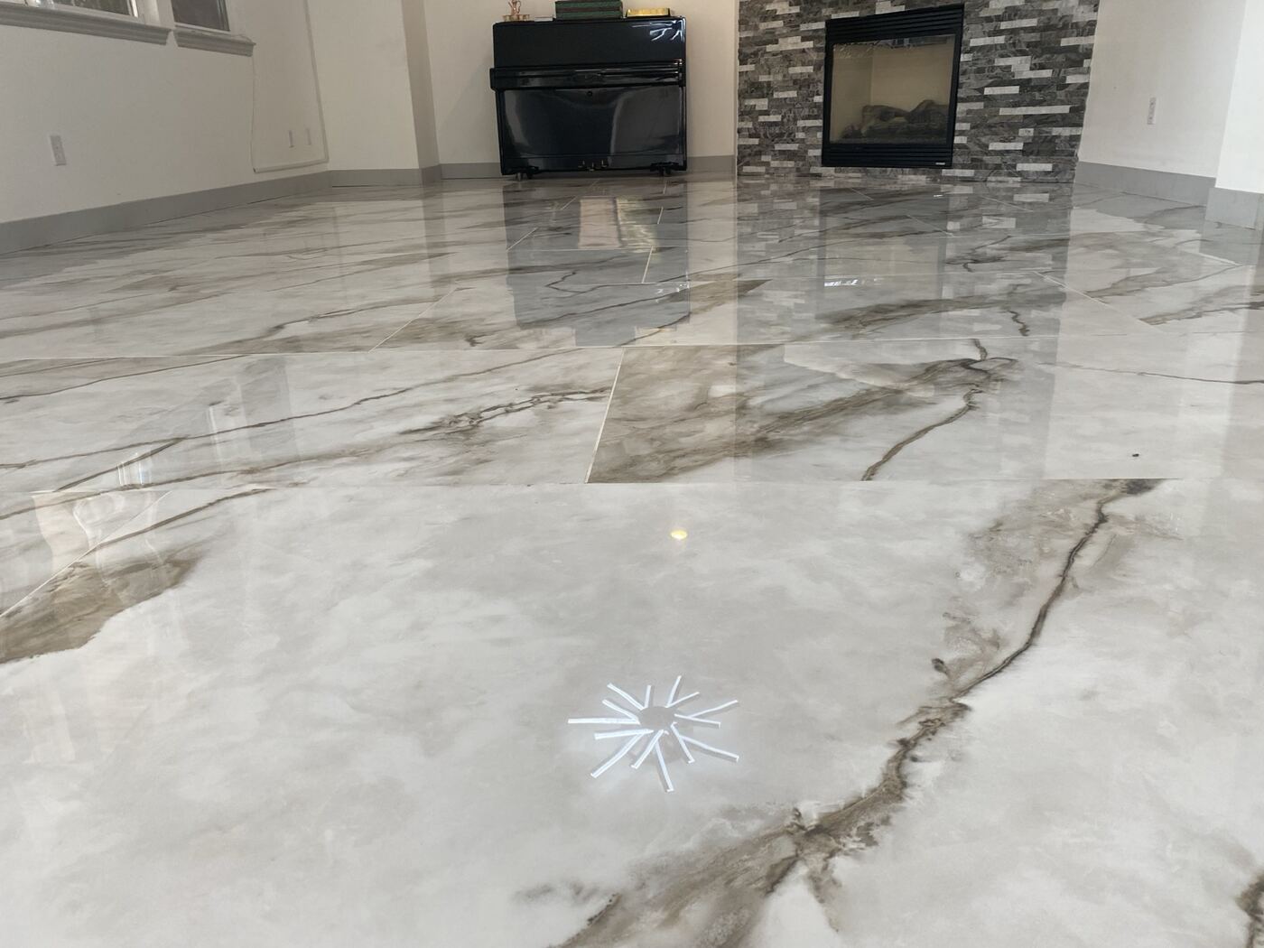Mirror-gloss marble tile with fireplace reflection after Timla polish